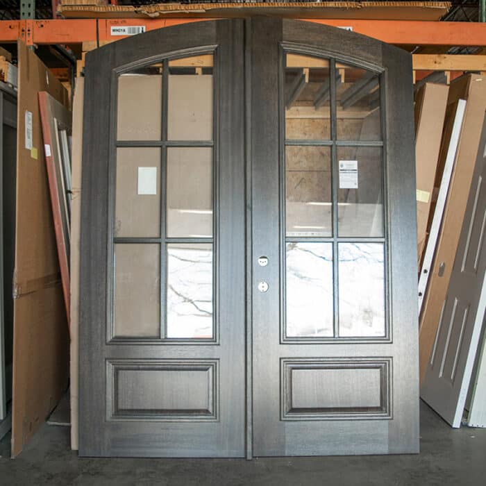 tall wooden double doors with arch top