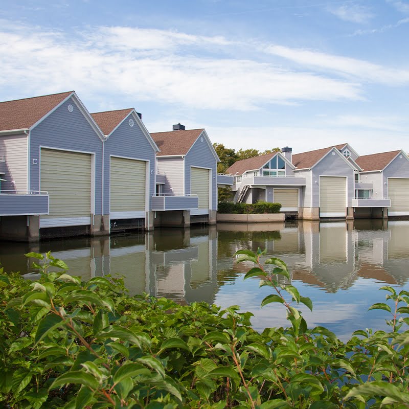 several lakefront homes with light blue siding