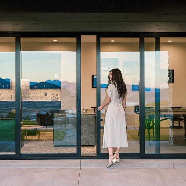 woman opening large sliding patio door