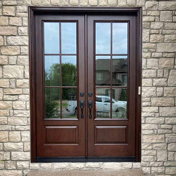 cherry stained french door on stone house