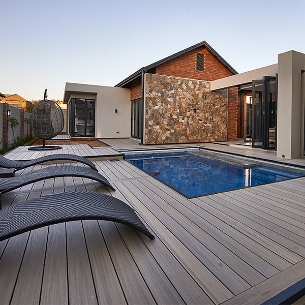 composite wood decking surrounding pool in backyard