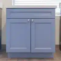 blue vanity cabinet with silver finishes and two doors