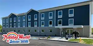 three story dormitory building with colorful siding and white vinyl windows