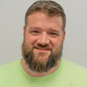 troy-greenwell adult male with brown facial hair and short brown hair wearing a green shirt
