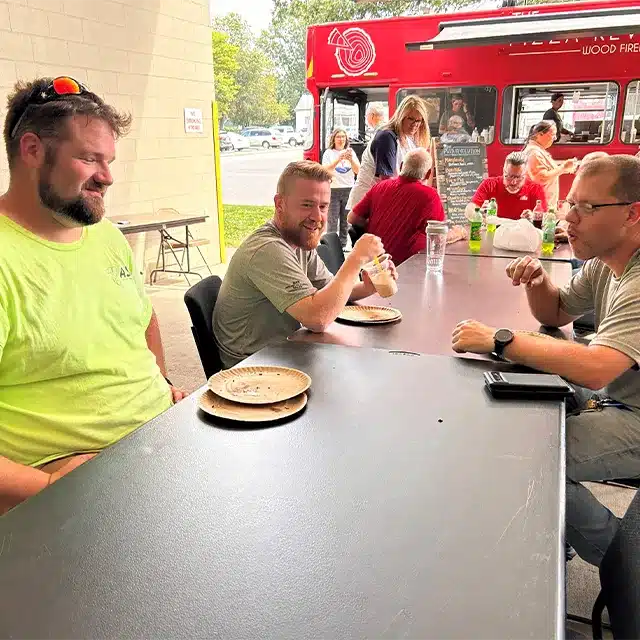 working professionals enjoying lunch outdoors at a company function
