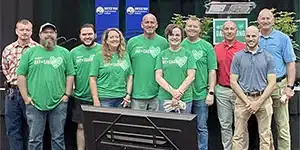 several adults posing for a group photo at a united way event