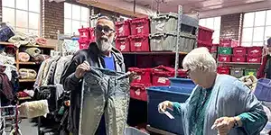 adults volunteering at a clothing bank